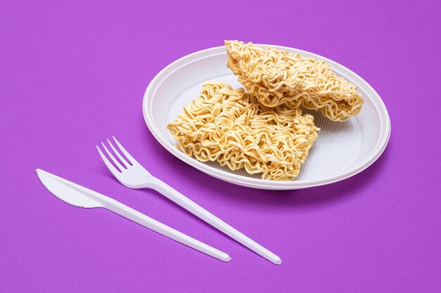 Uncooked instant noodles on white plate