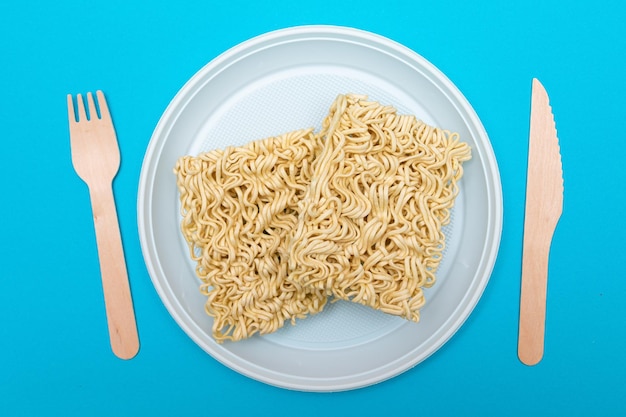 Uncooked instant noodles on white plate