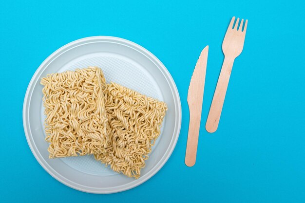 Uncooked instant noodles on white plate