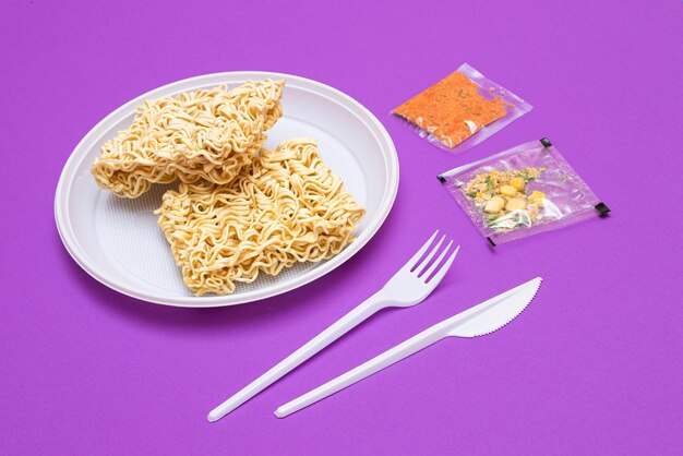 Uncooked instant noodles on white plate