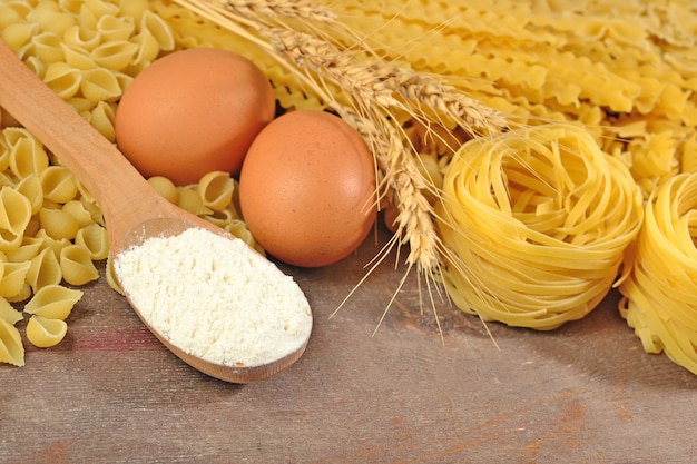 Uncooked Italian pasta, flour and eggs