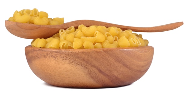 Uncooked italian pasta pipe rigate in a wooden bowl on a white background