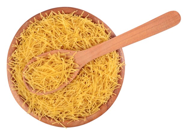 Uncooked italian pasta in a wooden bowl on a white background