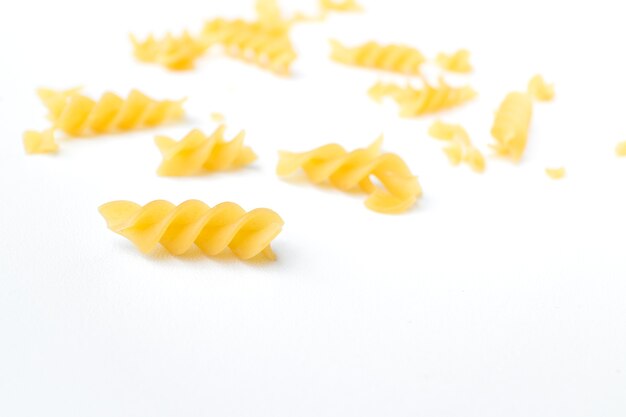 Uncooked macaroni isolated on a white space. Dry macaroni pasta isolated