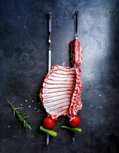 Uncooked meat on dark backdrop