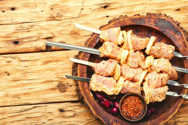 Uncooked meat skewers for picnic.Raw kebab from meat on a wooden table