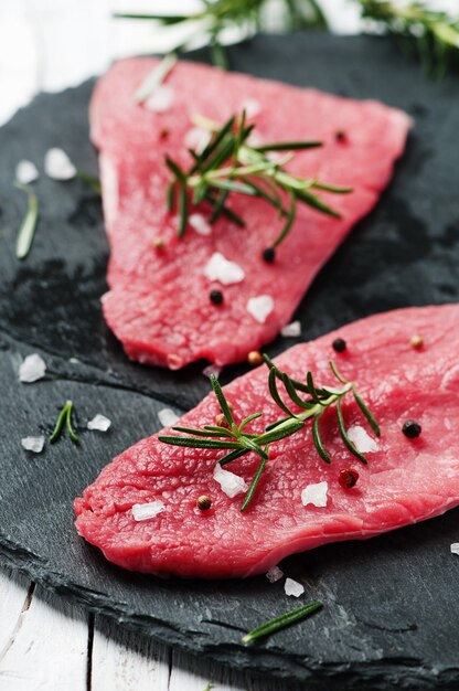 Uncooked meat with rosemary and salt