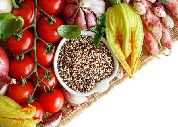 Uncooked mixed quinoa with vegetables isolated on white