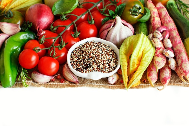 Uncooked mixed quinoa with vegetables isolated on white