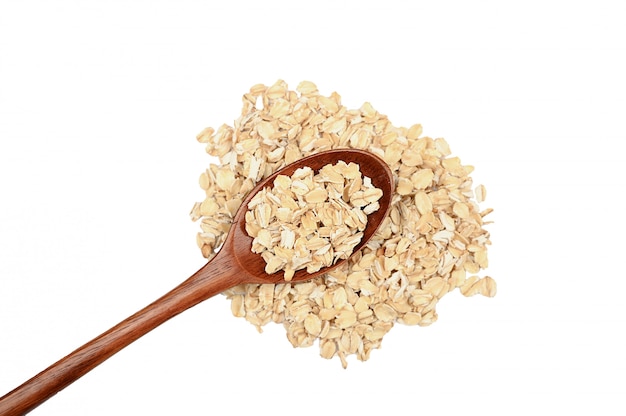 Uncooked oatmeal in the wooden spoon