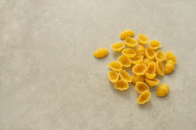 Uncooked pasta on gray background