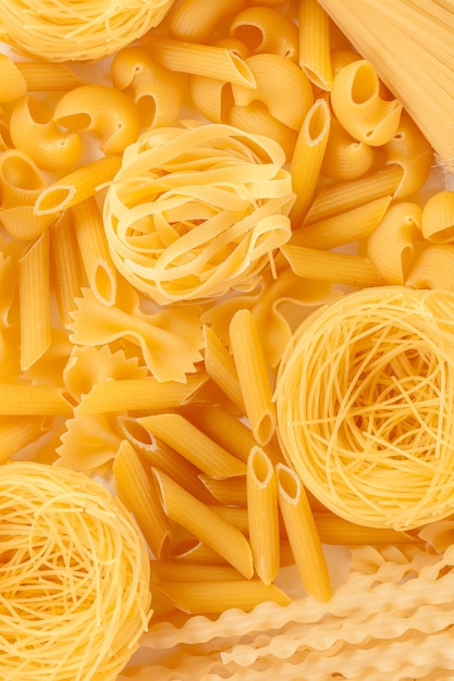 Uncooked pasta on white