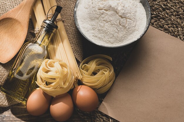 Uncooked pasta on a wooden background