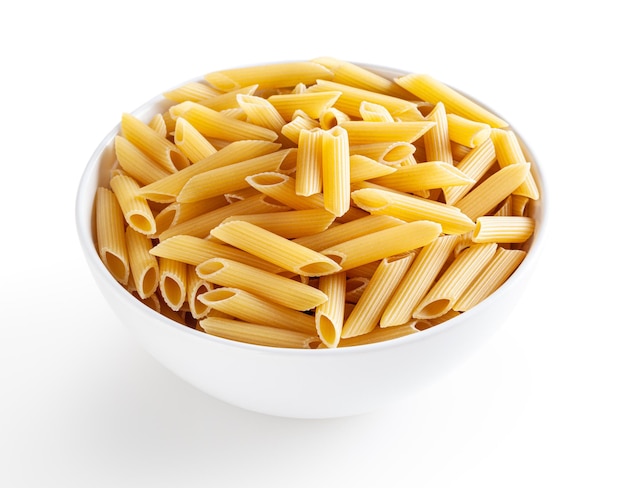 uncooked penne pasta in white bowl isolated on white background with clipping path