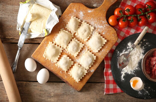 Uncooked ravioli on cutting board