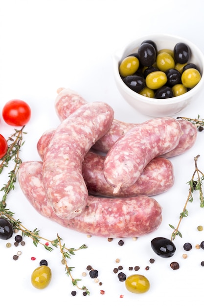 Uncooked raw sausages with serving spices