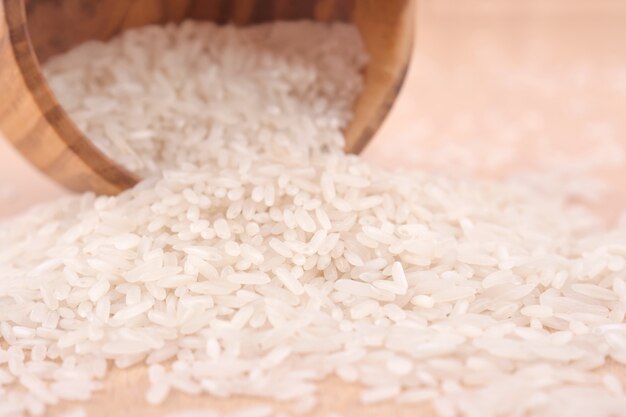 Uncooked rice in a wooden bowl