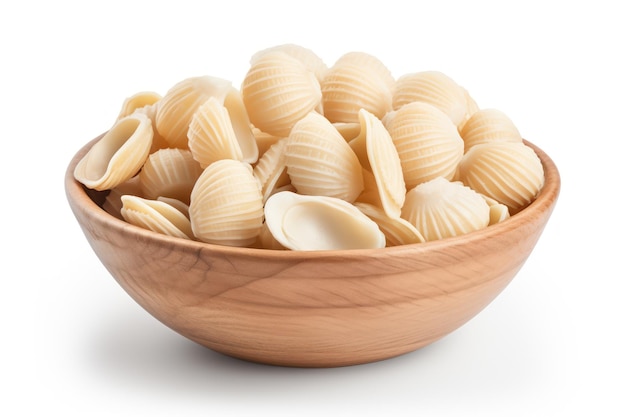 Uncooked shell pasta in ceramic bowl isolated on white background with full depth of field