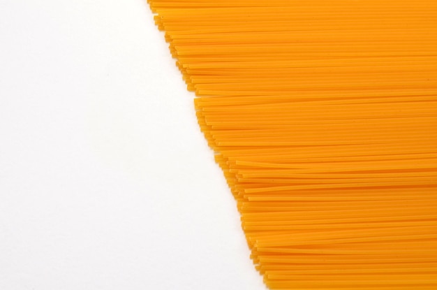 Uncooked spaghetti on white background copy space