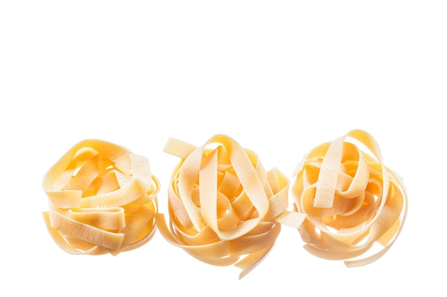 Uncooked twisted macaroni isolated on white