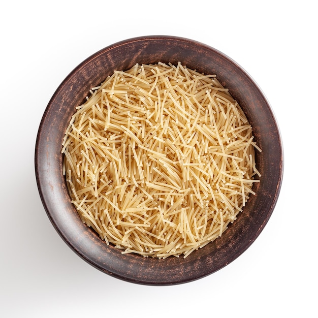 Uncooked vermicelli pasta in ceramic bowl isolated on white background with clipping path