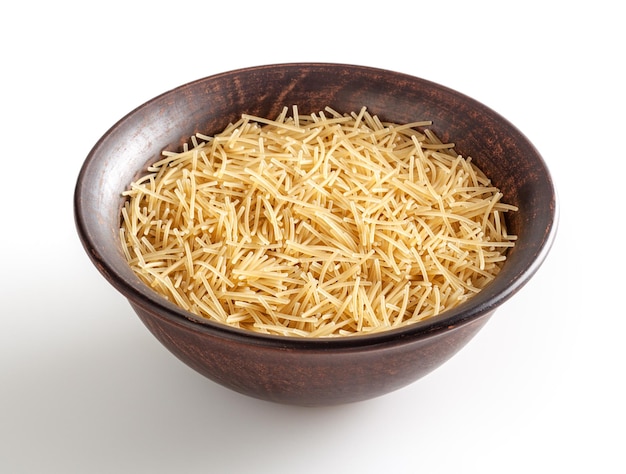 Uncooked vermicelli pasta in ceramic bowl isolated on white background with clipping path