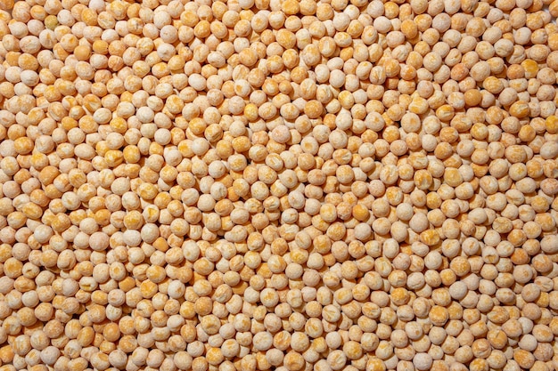 Uncooked yellow polished peas background