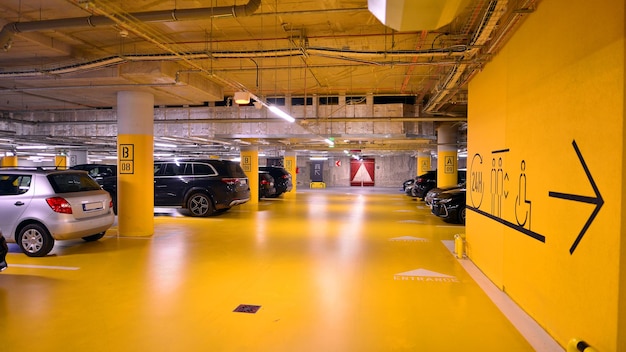 Underground parking under shopping center Car parking garage with lighting and columns