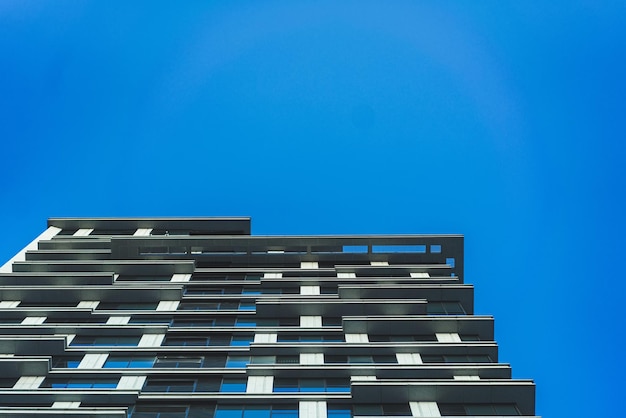 Underside panoramic and perspective view to steel blue glass high rise building skyscrapers business concept of successful industrial architecture