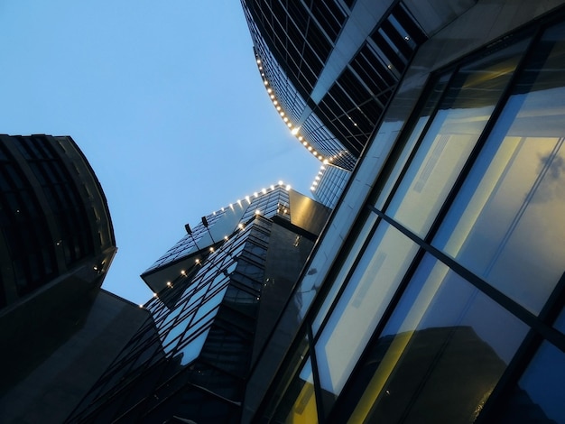 Underside View of Modern Building with Outdoor Illumination At Night