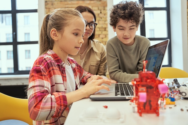 Understand how technology works cute little girl learn programming using laptop during stem class