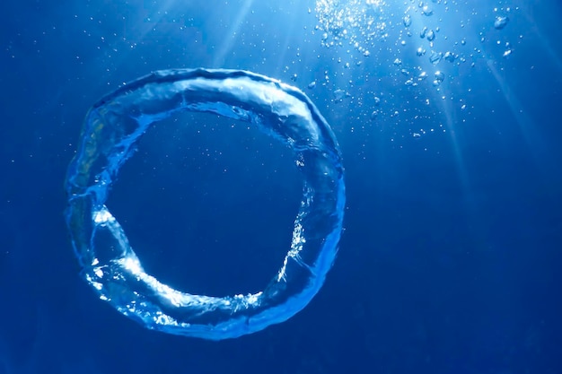 Photo underwater bubble ring ascends towards the sun