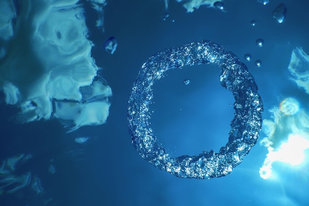 Photo underwater bubble ring ascends towards the sun