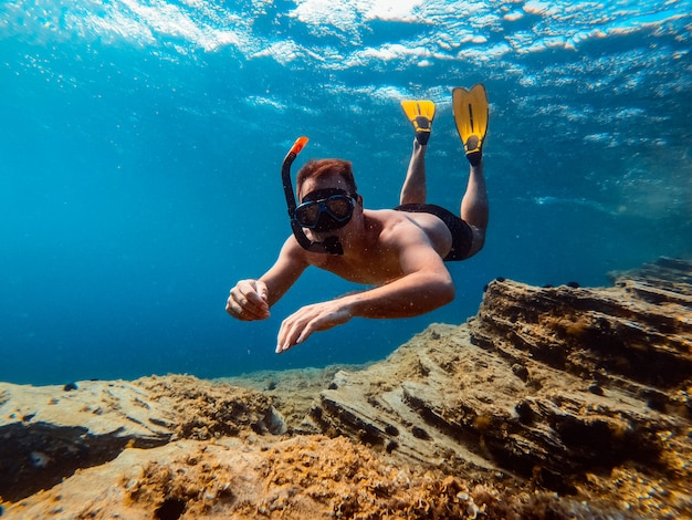 Underwater photo of men snorkeling in the sea water