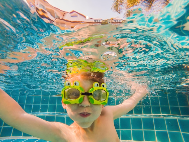 Underwater Young Boy Fun in the Swimming Pool with Goggles Summer Vacation Fun