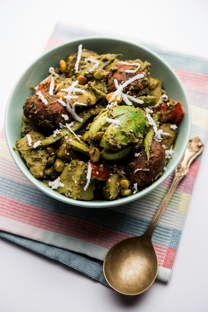 Undhiyu is a Gujarati mixed vegetable dish, specialty of Surat, India. Served in a bowl with or without poori