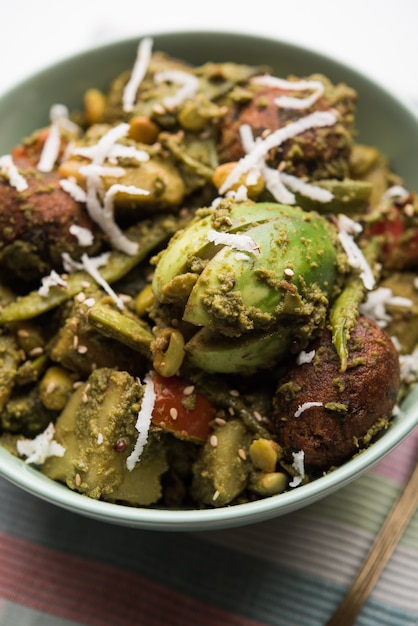 Undhiyu is a Gujarati mixed vegetable dish, specialty of Surat, India. Served in a bowl with or without poori