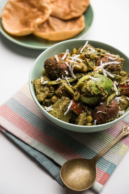 Undhiyu is a Gujarati mixed vegetable dish, specialty of Surat, India. Served in a bowl with or without poori