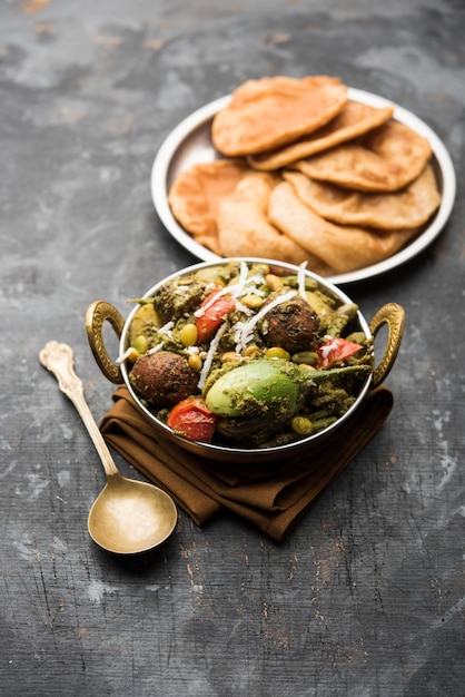 Undhiyu is a Gujarati mixed vegetable dish, specialty of Surat, India. Served in a bowl with or without poori