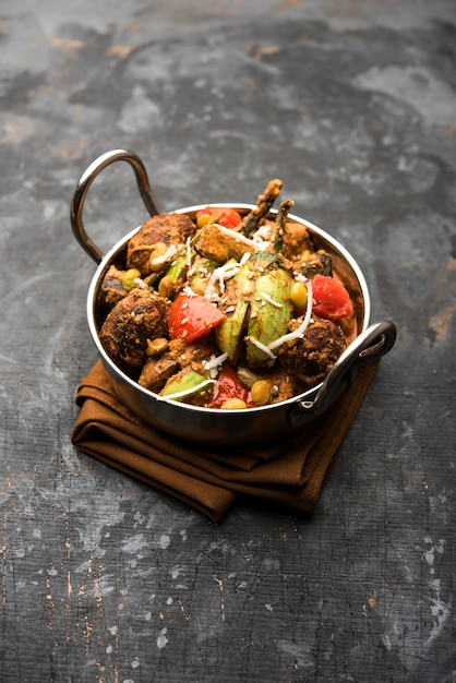 Undhiyu is a Gujarati mixed vegetable dish, specialty of Surat, India. Served in a bowl with or without poori