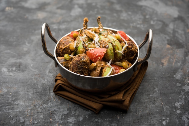 undhiyu is a gujarati mixed vegetable dish, specialty of surat, india. served in a bowl with or without poori