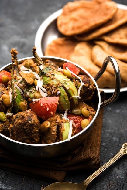 undhiyu is a gujarati mixed vegetable dish, specialty of surat, india. served in a bowl with or without poori
