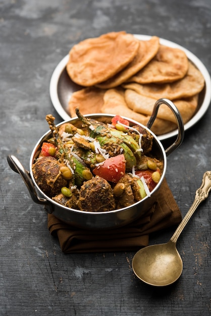 Undhiyu is a Gujarati mixed vegetable dish, specialty of Surat, India. Served in a bowl with or without poori