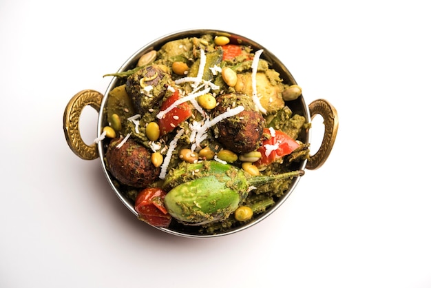 Undhiyu is a Gujarati mixed vegetable dish, specialty of Surat, India. Served in a bowl with or without poori