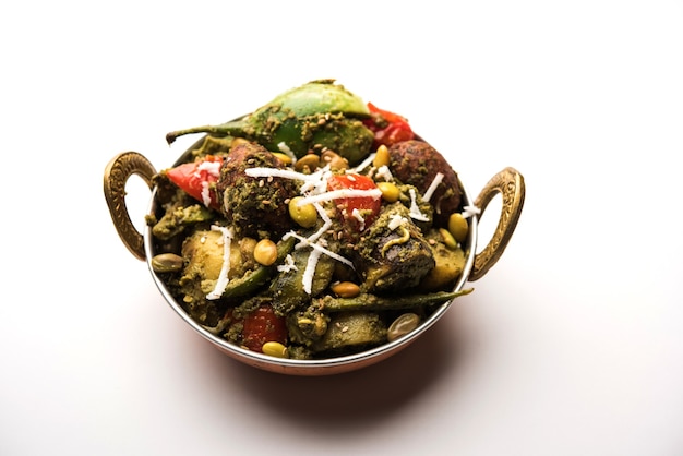 Undhiyu is a Gujarati mixed vegetable dish, specialty of Surat, India. Served in a bowl with or without poori