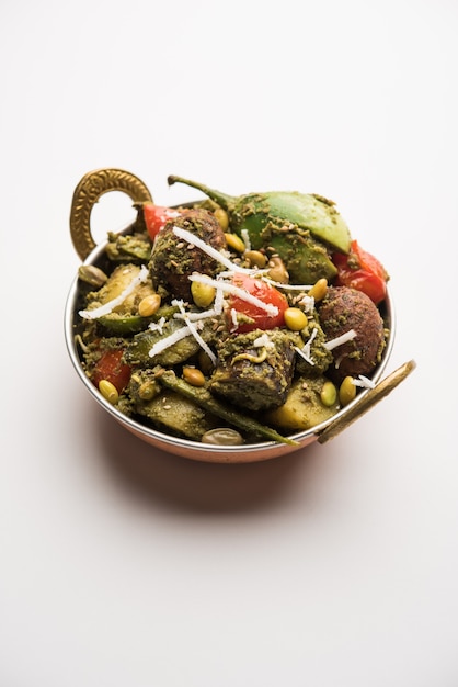 Undhiyu is a Gujarati mixed vegetable dish, specialty of Surat, India. Served in a bowl with or without poori