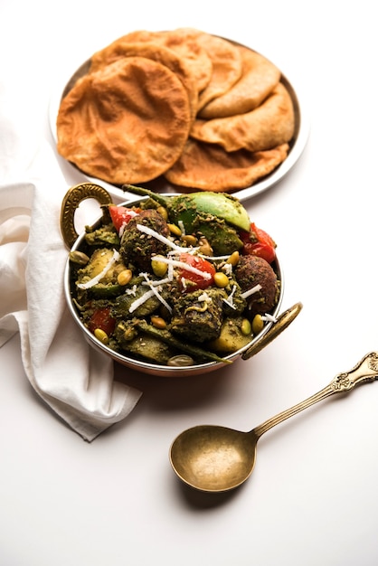 Undhiyu is a Gujarati mixed vegetable dish, specialty of Surat, India. Served in a bowl with or without poori