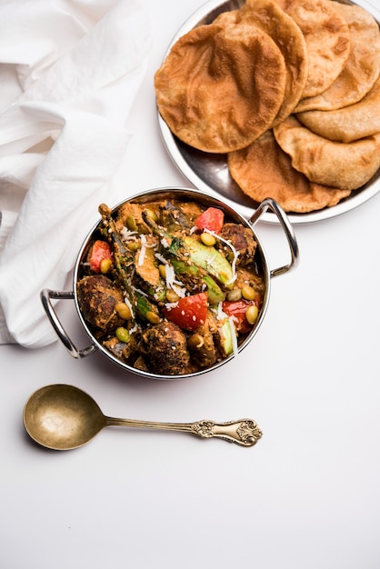 undhiyu is a gujarati mixed vegetable dish, specialty of surat, india. served in a bowl with or without poori