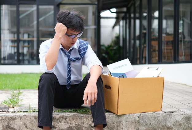 Unemployed Businessman Sitting with Box After Losing Job