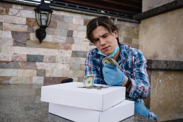 An unemployed man shows an empty wallet being fired and losing his job during illness and quarantine